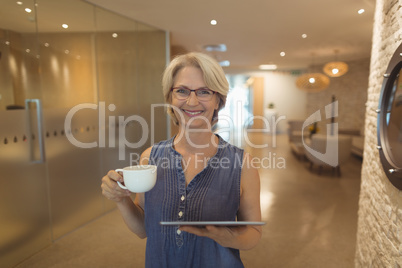 Portrait of smiling businesswoman with coffee