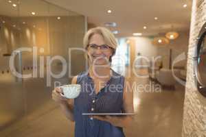 Portrait of smiling businesswoman with coffee