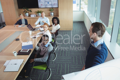 Serious business entrepreneur explaining strategy to colleagues at office