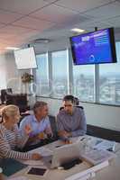 High angle view of focused business partners discussing at office