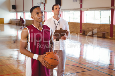 Thoughtful basketball player with coach