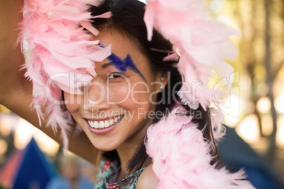 Portrait of happy woman holding fur scarf