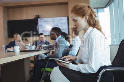 Side view of businesswoman using digital tablet at office
