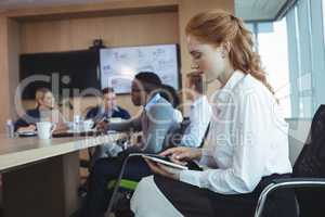 Side view of businesswoman using digital tablet at office