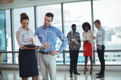 Young business colleagues discussing at office