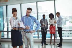 Young business colleagues discussing at office