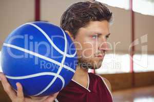 Close up of serious basketball player holding ball