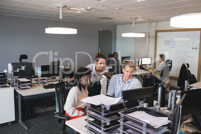 Business colleagues discussing at desk