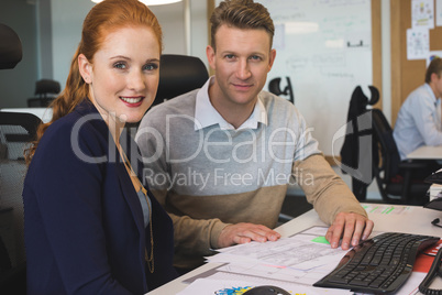 Portrait of young business colleagues working together in office