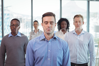 Business people with eyes closed at office