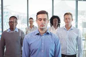 Business people with eyes closed at office