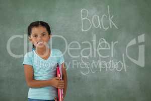 Young girl holding books