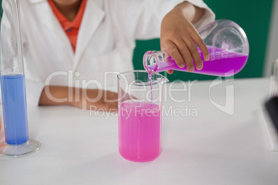 Schoolboy experimenting in laboratory