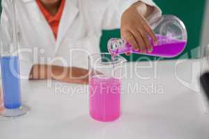 Schoolboy experimenting in laboratory
