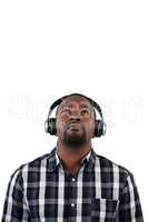 Man listening to music on headphones against white background