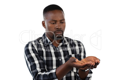 Man standing with hands cupped against white background