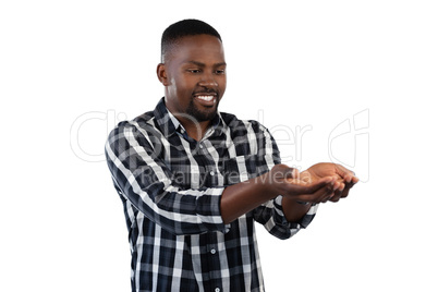 Man standing with hands cupped against white background