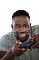 Smiling man playing video game against white background