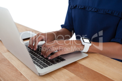 Businesswoman using laptop on the table