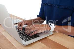 Businesswoman using laptop on the table