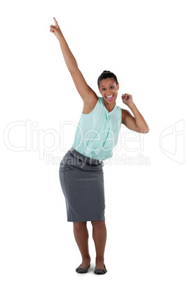 Excited businesswoman dancing against white background