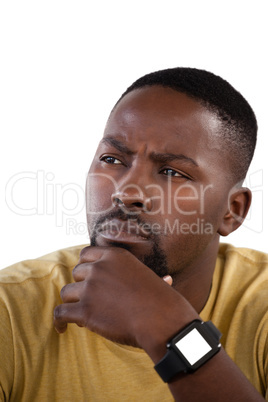 Man with hand on chin against white background