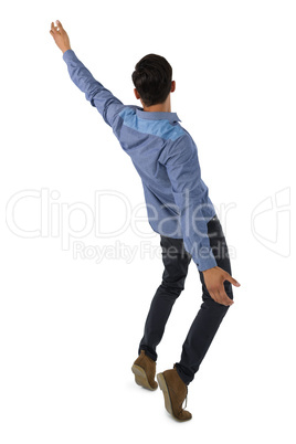 Rear view of businessman balancing