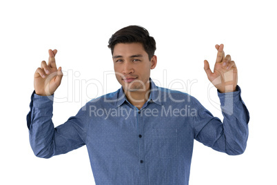 Portrait of businessman with fingers crossed