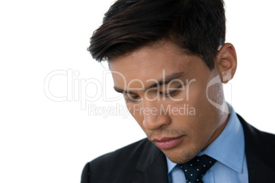 Close up of young businessman looking down