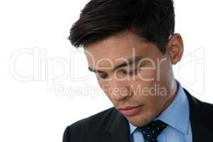 Close up of young businessman looking down