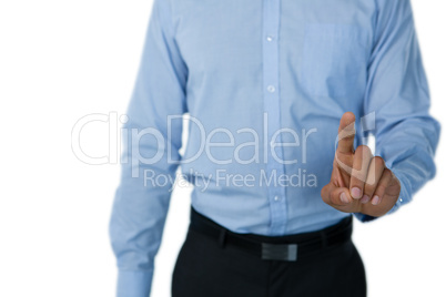 Mid section of businessman touching invisible screen