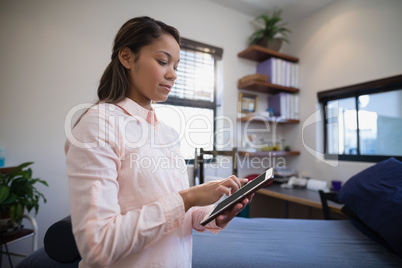 Young female doctor using digital tablet