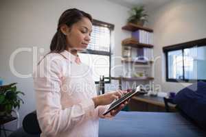 Young female doctor using digital tablet