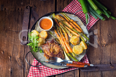 Grilled steak with vegetables and fried potatoes