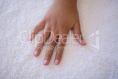 Overhead view of hand on white towel