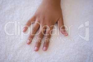 Overhead view of hand on white towel