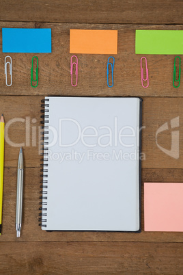 Various school supplies arranged on wooden table