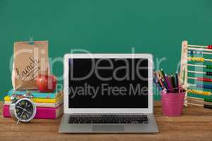 School supplies with laptop on wooden table