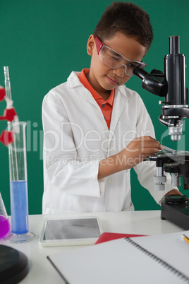 Schoolboy using microscope