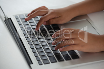 Schoolboy using laptop