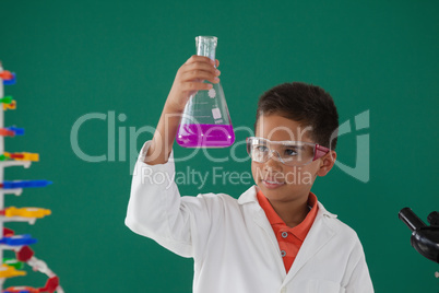 Attentive schoolboy doing a chemical experiment in laboratory