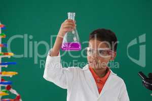 Attentive schoolboy doing a chemical experiment in laboratory