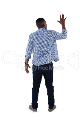 Man pretending to touch an invisible screen against white background