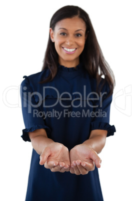 Smiling businesswoman with hand cupped against white background