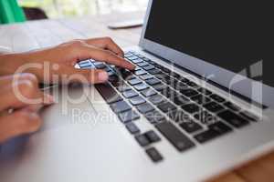 Businesswoman using laptop on the table