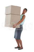Businesswoman carrying heavy boxes