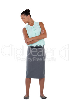 Businesswoman standing with arms crossed against white background