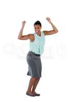 Excited businesswoman dancing against white background