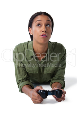 Woman playing video game against white background