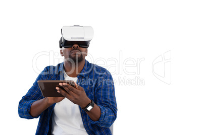 Man using virtual reality headset and digital tablet